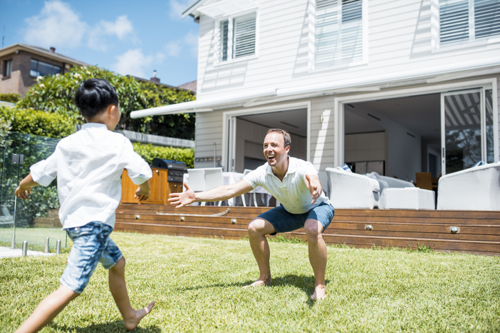father and son playing in the safety of their backyard used to depict the peace of mind provided by homeowners insurance